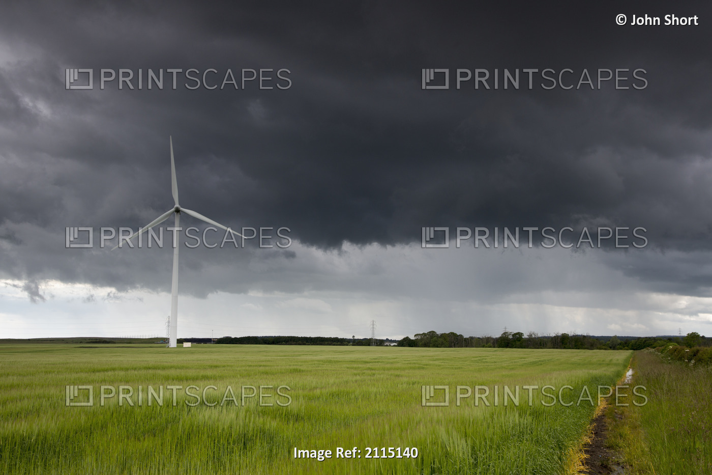 Wind turbine and storm clouds;Northumberland england