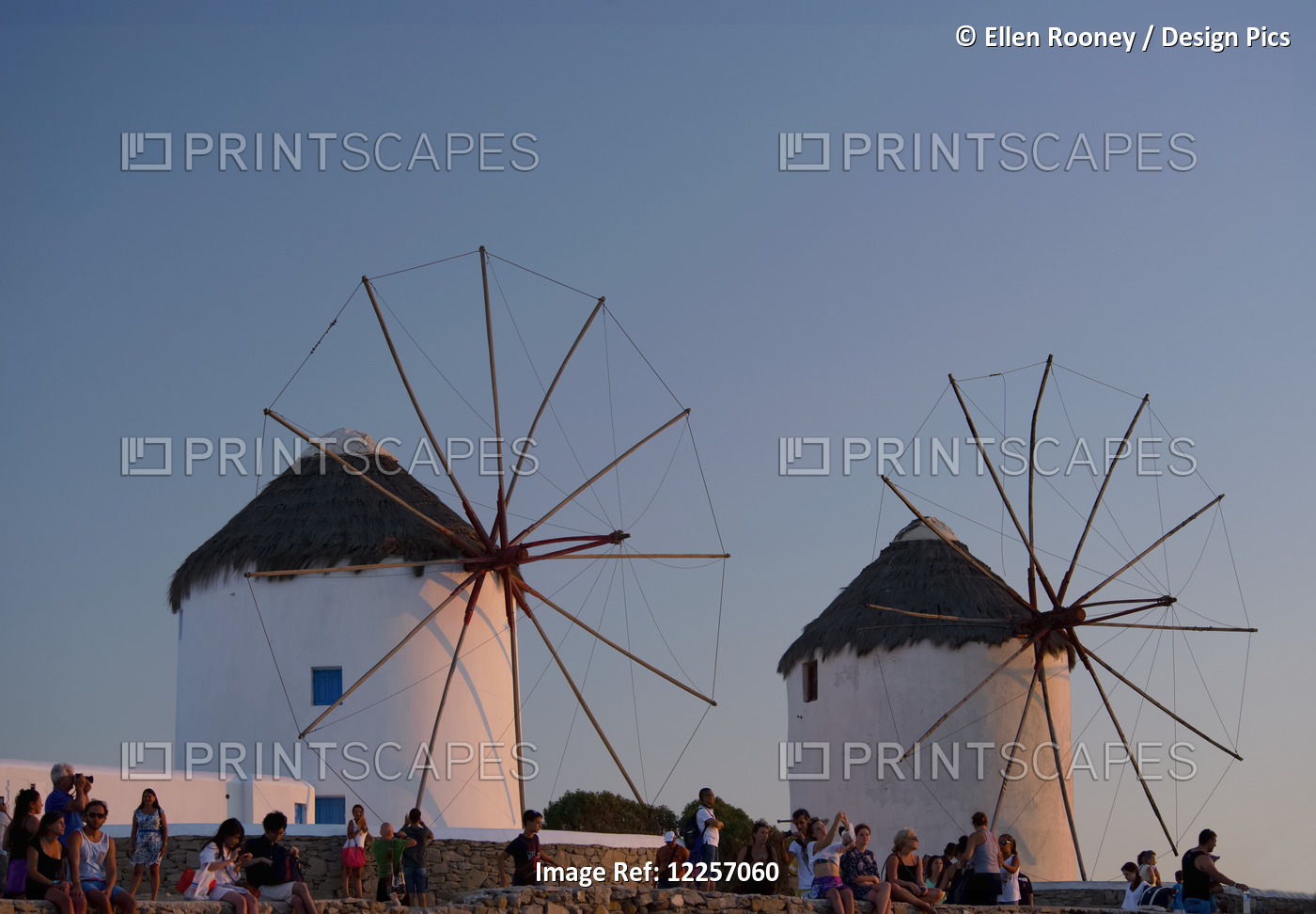 People Watching The Sunset Beneath Old Windmills; Mykonos Town, Mykonos, ...