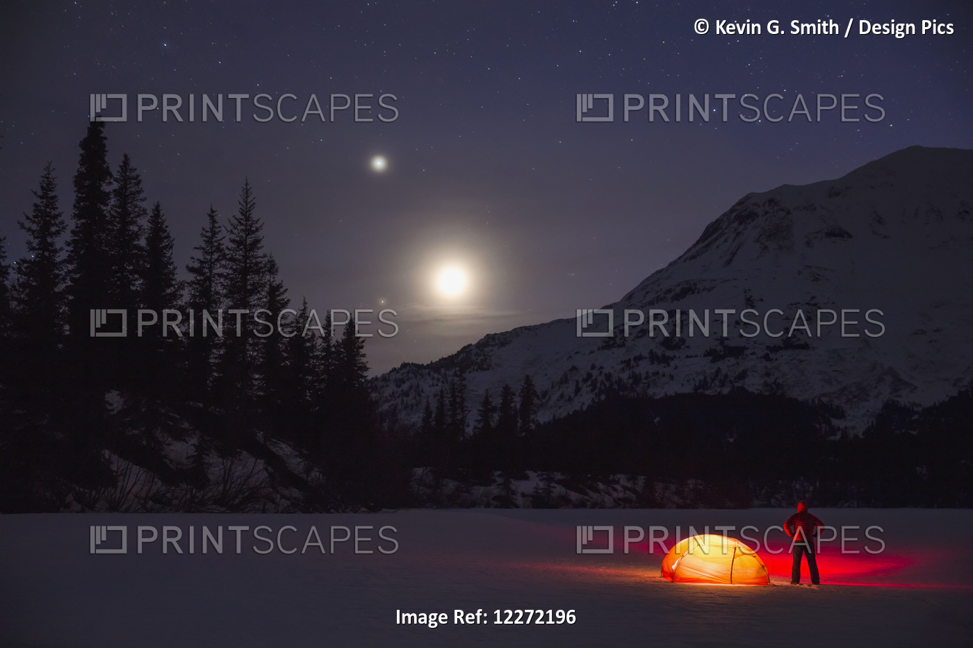 Nighttime View Of A Man Standing Next To A Lit Tent On A Snow Covered Trail ...