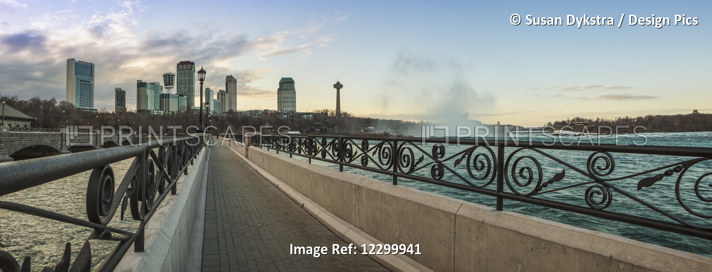 A walkway with a city skyline in the background; Niagara Falls, Ontario, Canada