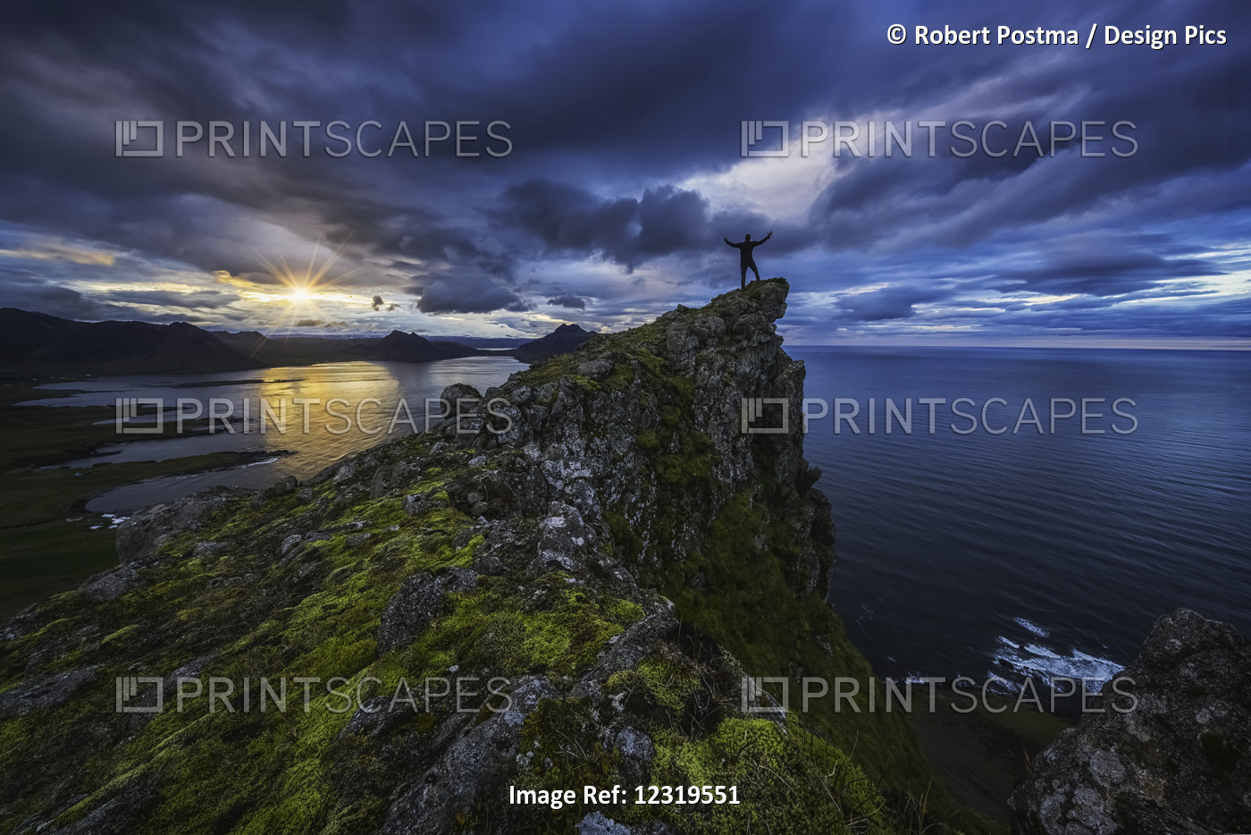 Man Standing On Top Of A Sea Cliff At Sunset Along Iceland's Strandir Coast In ...