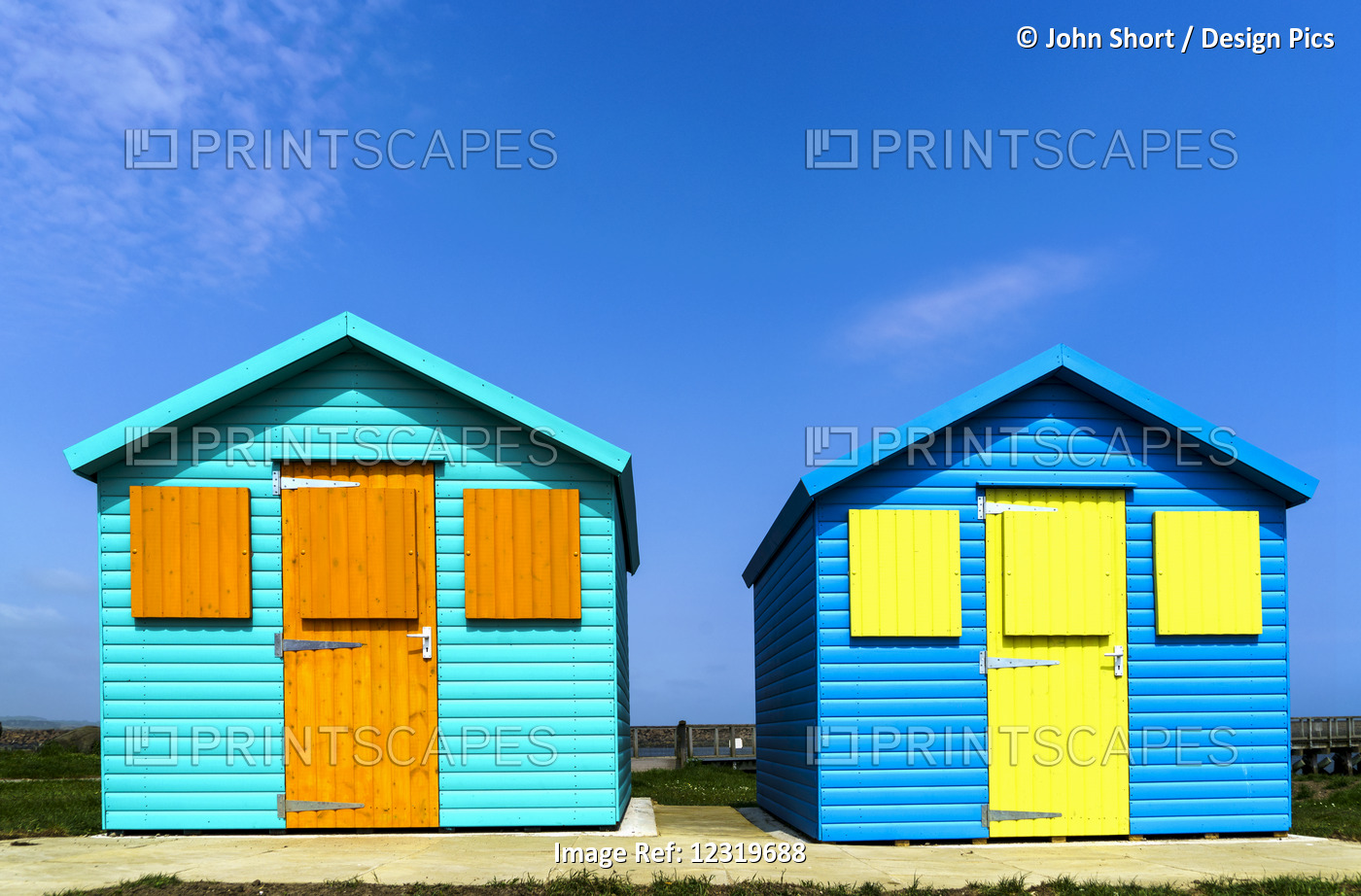 Two Colourful Buildings Side By Side With Boarded Up Windows; Amble, ...