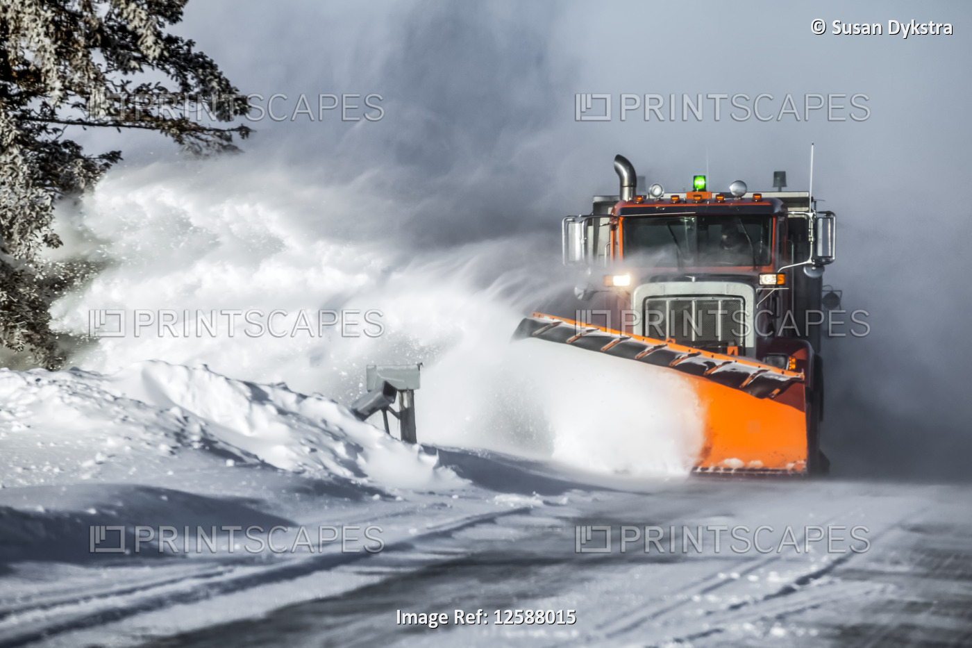 Snow plow throwing fresh snow to the side of the road; Sault St. Marie, ...