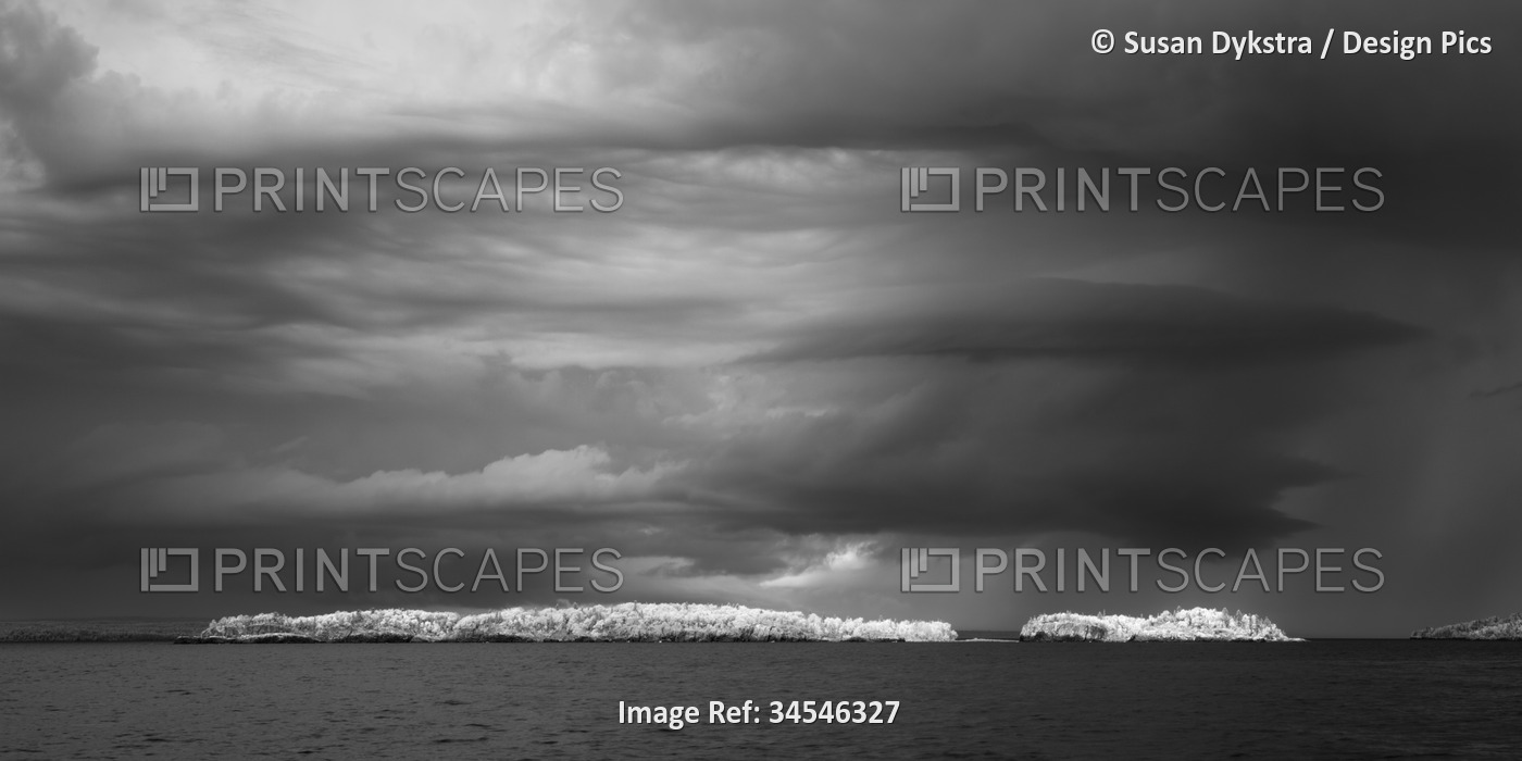 Dramatic cloud formation over rocks in Lake Superior in infrared
